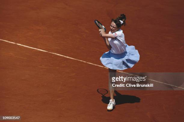 Martina Hingis of Switzerland makes a return against Lindsay Davenport during their Women's Singles match at the French Open Tennis Championship on...