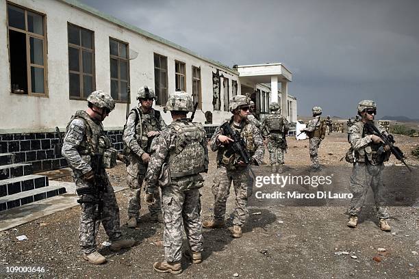 Army soldiers from the 4th Brigade, 25th Infantry Division secure a school during a mission of the US Army Embedded Training Team and Human Terrain...