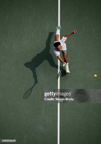 Michael Chang of the United States races his shadow ouitstretched down the baseline during his Men's Singles match against Patrick McEnroe at the...