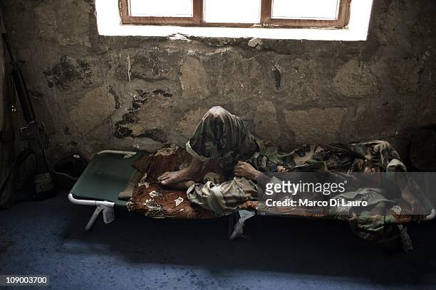 An Afghan National Army soldier sleeps in a school during a mission of the US Army Embedded Training Team and Human Terrain Team to inspect pooling...