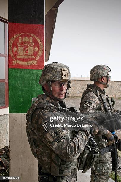 Army SFC Timothy Burd from Georgia Alpha Company 1/121 Infantry , 48th BCT secure a school during a mission of the US Army Embedded Training Team and...