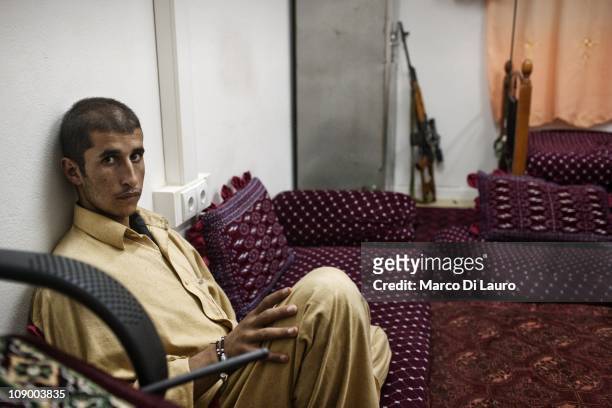 Afghan national Mohammed Ibrahim, body guard and driver of the Sub Governor of Spera district seats in a room on August 9, 2009 at the ANA 2nd...