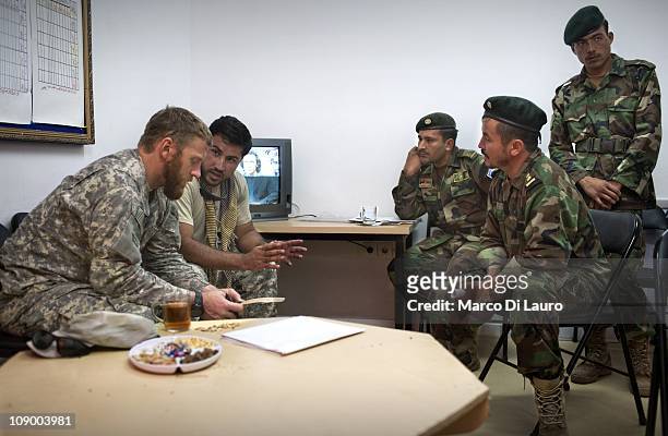 Civilian anthropologist and HTT Social Scientist, Ted Callahan, 35-years old, from Boston, Massachusetts talk to Afghan National Army soldiers on...