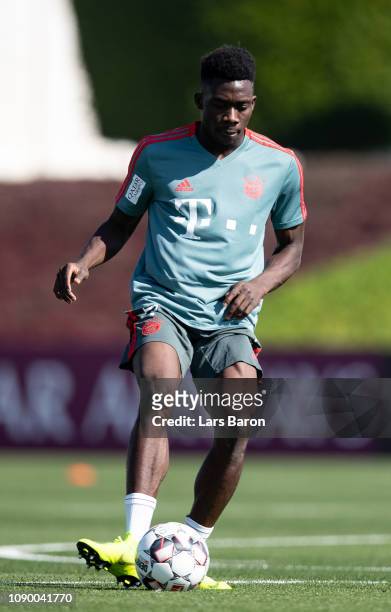 Alphonso Davies runs with the ball during a training session at day two of the Bayern Muenchen training camp at Aspire Academy on January 05, 2019 in...