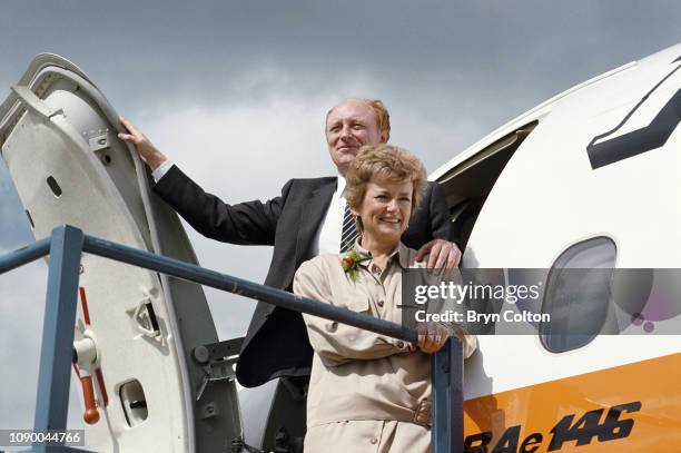 Neil Kinnock, leader of the Labour Party and member of Parliament, and his wife Glenys Kinnock, stand on the steps of a BAE 146 aircraft at the...