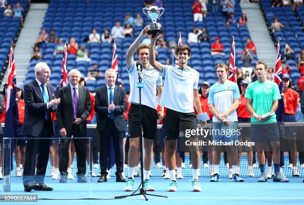 Pierre-Hugues Herbert and Nicolas Mahut of France pose with the championship trophy after their Men's Doubles Final match against John Peers of...