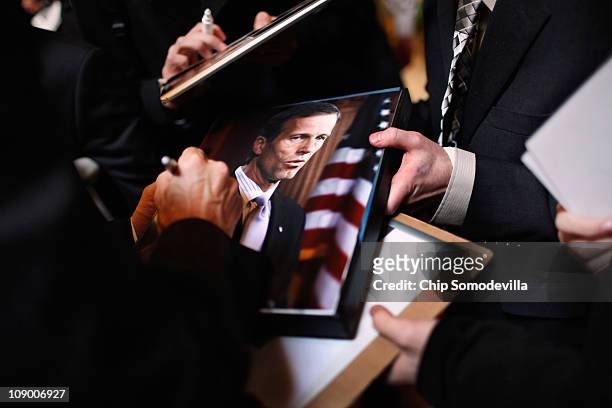 Sen. John Thune signs autographs and poses for photographs with supporters in the lobby of the Marriott Wardman Park hotel during the Conservative...