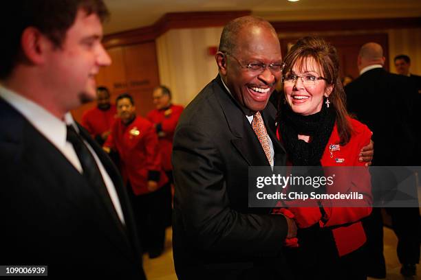 Sarah Palin impersonator Patti Lyons shares a laugh with presidential hopeful Herman Cain in the lobby of the Marriott Wardman Park hotel during the...