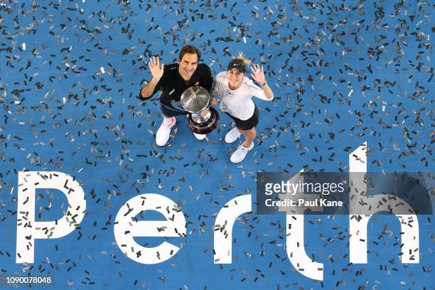 Roger Federer and Belinda Bencic of Switzerland pose with the Hopman Cup after winning the final against Alexander Zverev and Angelique Kerber of...
