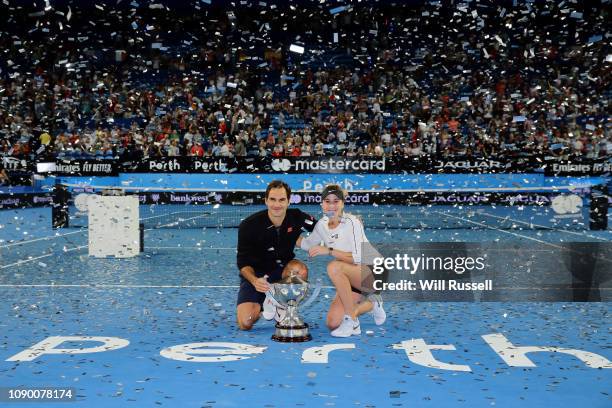 Belinda Bencic and Roger Federer of Switzerland with the Hopman Cup after defeating Angelique Kerber and Alexander Zverev of Germany in the final...