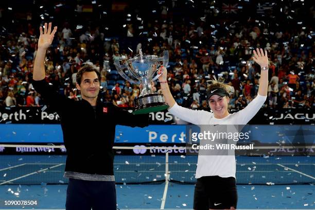 Roger Federer and Belinda Bencic of Switzerland celebrate with the Hopman Cup after defeating Angelique Kerber and Alexander Zverev of Germany in the...