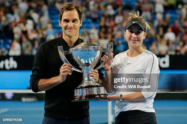 Roger Federer and Belinda Bencic of Switzerland celebrate with the Hopman Cup after defeating Angelique Kerber and Alexander Zverev of Germany in the...