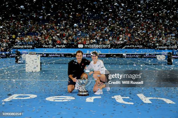 Roger Federer and Belinda Bencic of Switzerland celebrate with the Hopman Cup after defeating Angelique Kerber and Alexander Zverev of Germany in the...