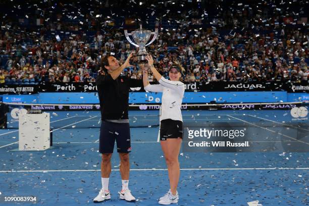 Roger Federer and Belinda Bencic of Switzerland pose with the Hopman Cup after defeating Angelique Kerber and Alexander Zverev of Germany in the...