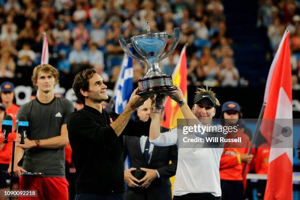 Roger Federer and Belinda Bencic of Switzerland raise aloft the Hopman Cup after defeating Angelique Kerber and Alexander Zverev of Germany in the...