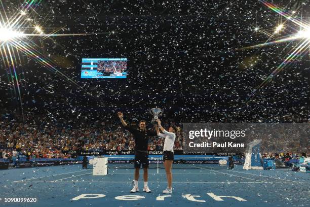 Roger Federer and Belinda Bencic of Switzerland pose with the Hopman Cup after winning the final against Alexander Zverev and Angelique Kerber of...