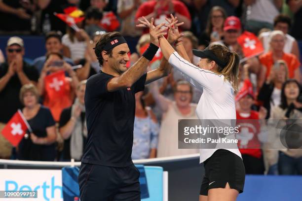 Roger Federer and Belinda Bencic of Switzerland celebrate winning the Hopman Cup final against Alexander Zverev and Angelique Kerber of Germany on...