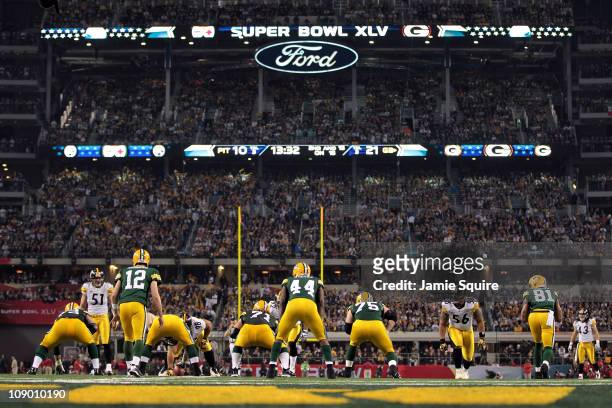 Quarterback Aaron Rodgers of the Green Bay Packers calls signals out of the shotgun formation against James Farrior, LaMarr Woodley and Troy Polamalu...