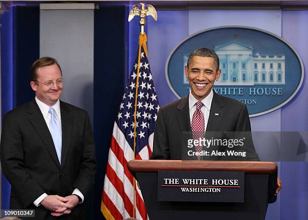 President Barack Obama and outgoing White House Press Secretary Robert Gibbs smile during the daily press briefing February 11, 2011 at the White...