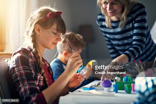 family painting easter eggs - easter poland stock pictures, royalty-free photos & images