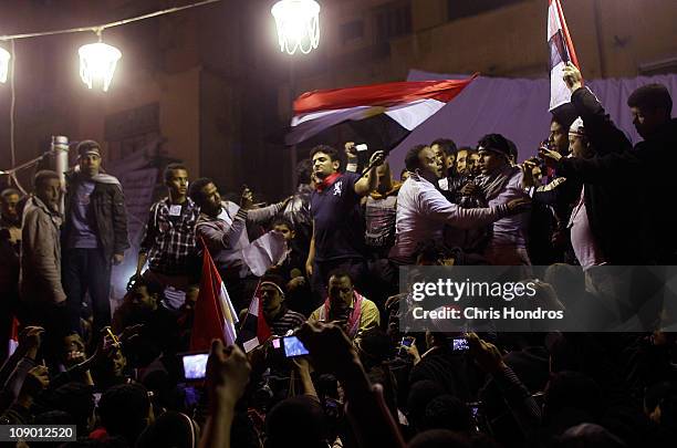 Wael Ghonim, a Google marketing executive and an Egyptian protest activist, waves the Egyptian flag on stage in Tahrir Square during celebrations...