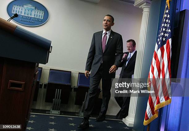 President Barack Obama and outgoing White House Press Secretary Robert Gibbs walk into the daily press briefing February 11, 2011 at the White House...