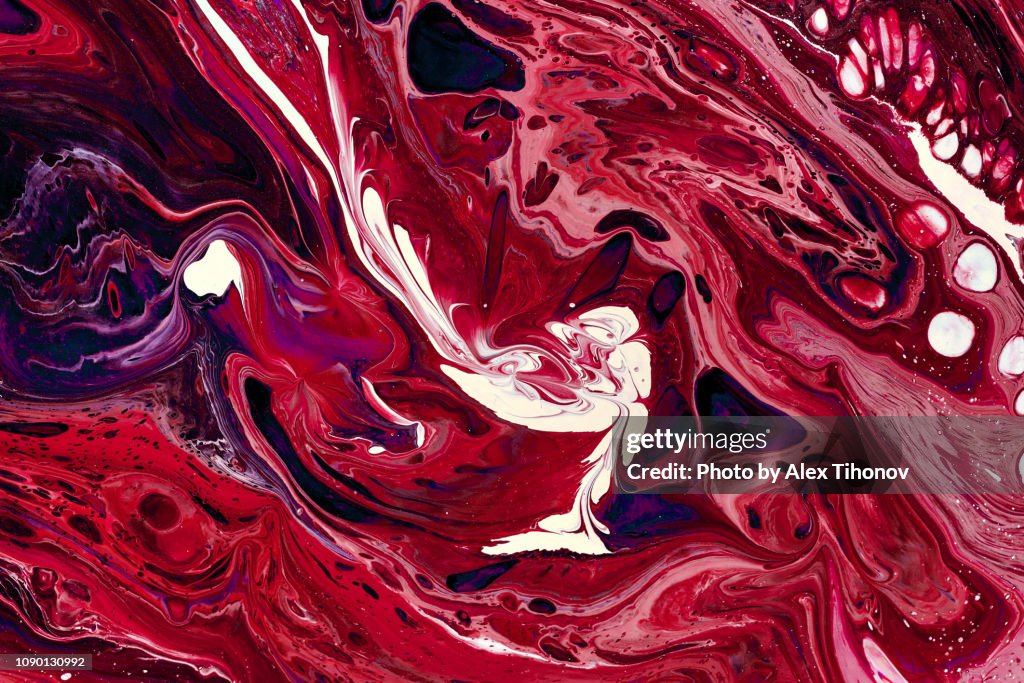 Abstract colourful background texture fluid art acrylic paints. Red colour