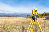 Theodolite on Tripod on a Meadow in Nature