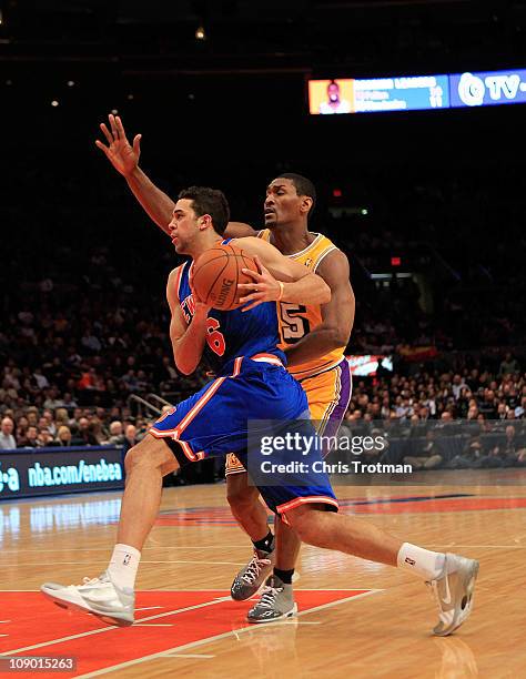 Landry Fields of the New York Knicks drives against Ron Artest of the Los Angeles Lakers at Madison Square Garden on February 11, 2011 in New York...