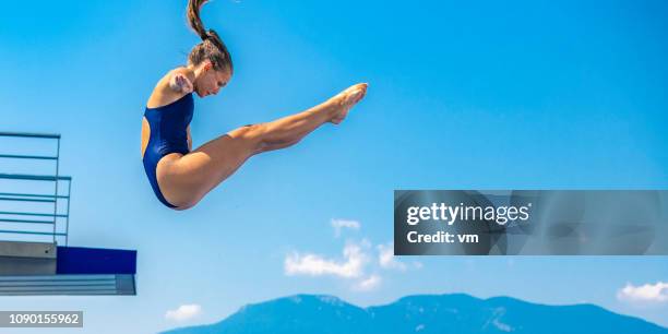 female springboard diver jump - high diving platform stock pictures, royalty-free photos & images