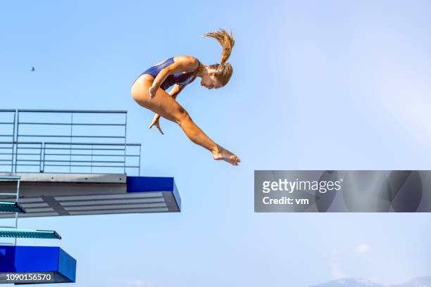 female springboard diver jump - high diving platform stock pictures, royalty-free photos & images