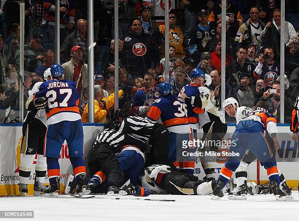 The Pittsburgh Penguins and The New York Islanders get tangled up on February 11, 2011 at Nassau Coliseum in Uniondale, New York. The Islanders...