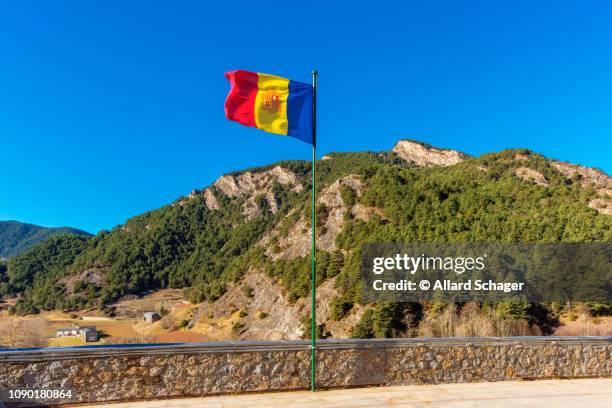 national flag of andorra waving in village of ordino andorra - andorra stock pictures, royalty-free photos & images