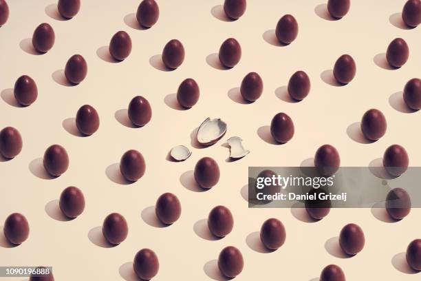 multiple chocolate eggs placed in a pattern, one of a kind - påskägg bildbanksfoton och bilder