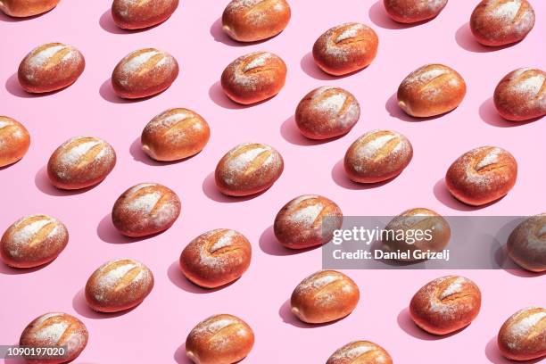 multiple bread rolls placed in a pattern - roll foto e immagini stock