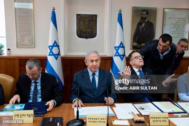 Israeli Prime Minister Benjamin Netanyahu, Cabinet Secretary Tzachi Braverman and Tourism Minister Yariv Levin attend the weekly cabinet meeting at...