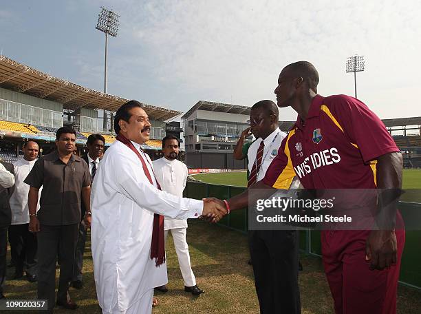 The President of Sri Lanka Mahinda Rajapaksa shakes hands with Darren Sammy captain of West Indies ahead of the Kenya v West Indies 2011 ICC World...