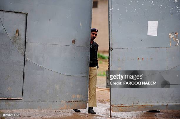 Pakistani policeman closes the gate of Adiala prison in Rawalpindi on February 12 after the case hearing of assassination of ex-prime minister...