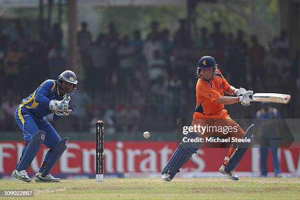 Tom de Grooth of Netherlands hits square as Kumar Sangakkara looks on during the Sri Lanka v Netherlands 2011 ICC World Cup Warm Up match at the...