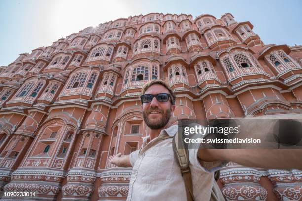 young man taking selfie portrait in front of palace in india -hawa mahal palace in jaipur, india - tourism stock pictures, royalty-free photos & images