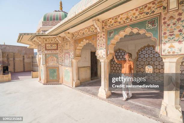 young woman traveling in india contemplating ancient temple in jaipur, india - india tourism stock pictures, royalty-free photos & images