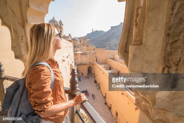 young woman traveling in india contemplating ancient temple in jaipur, india - india tourist stock pictures, royalty-free photos & images