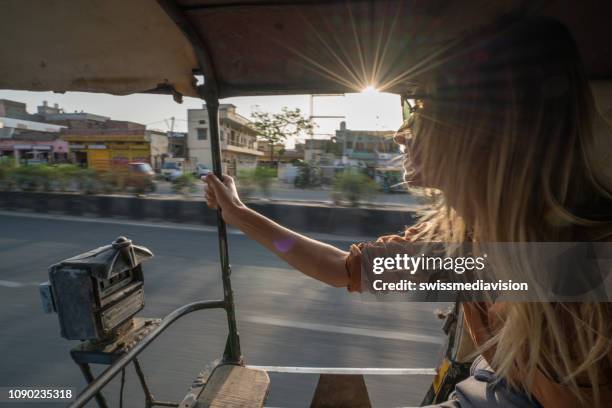 young woman riding on rickshaw in india traveling and discovering the country - brouette stock pictures, royalty-free photos & images