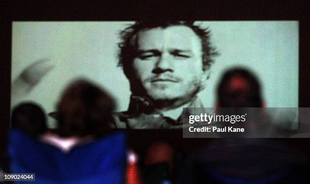 Film goers watch The Dark Knight featuring Heath Ledger during a public tribute outdoor movie night to the late actor at Burswood Park on February...