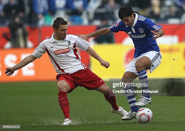 Erik Jendrisek of Freiburg challenges Raúl Gonzalez of Schalke during the Bundesliga match between FC Schalke 04 and SC Freiburg at Veltins Arena on...