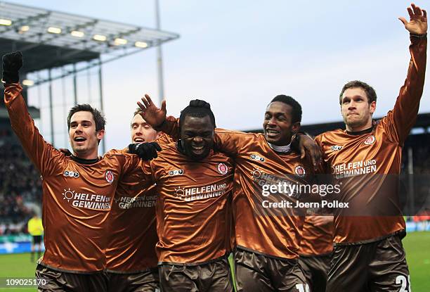 Gerald Asamoah of St.Pauli celebrates with his team mates after scoring his team's second goal during the Bundesliga match between FC St.Pauli and...