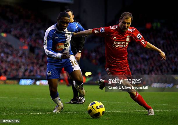 Charles N' Zogbia of Wigan Athletic competes with Milan Jovanovic of Liverpool during the Barclays Premier League match between Liverpool and Wigan...