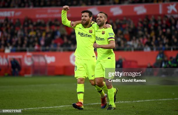 Lionel Messi of Barcelona celebrates after scoring his team's second goal with Jordi Alba of Barcelona during the La Liga match between Girona FC and...