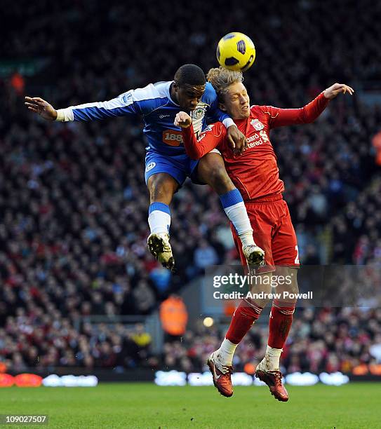 Steve Gohouri of Wigan and Lucas of Liverpool compete during the Barclays Premier League match between Liverpool and Wigan Athletic at Anfield on...