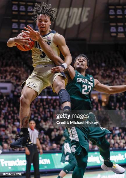 Carsen Edwards of the Purdue Boilermakers snags a rebound against Xavier Tillman of the Michigan State Spartans during the first half at Mackey Arena...